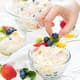White ice cream with berries in a glass bowl