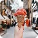 Red ice cream cone in hand